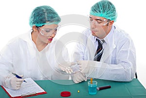 Two pharmacists people examine pills