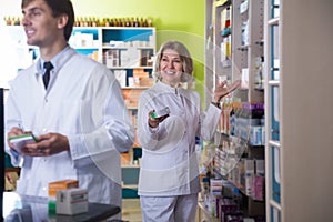 Two pharmacists posing in drugstore