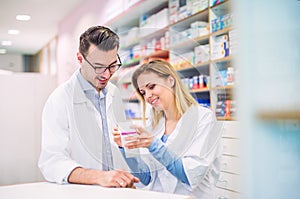 Two pharmacists working in a drugstore.