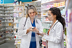Two pharmacists working together at pharmacy