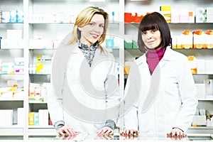 Two Pharmacy chemist women in drugstore