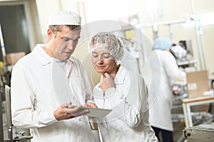 Two pharmacy industry workers with tablet pc