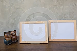 Two photo Frame and toy cat on a wooden