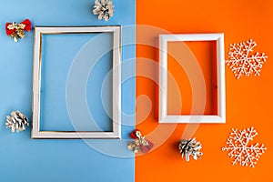 Two photo frames and Christmas decorations on color background, copy space for the text. Template for Christmas greeting card.