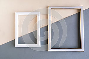 Two photo frames on geometric white and grey background,