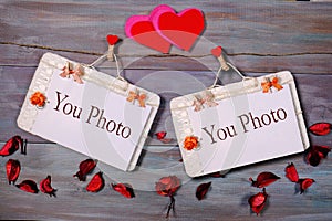 Two photo paper attach to rope with clothes pins on wooden background