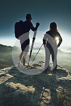 Two photographers meet at sunrise or dawn in the mountains