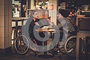 Two physically challenged women in a cafe