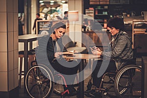 Two physically challenged women in a cafe