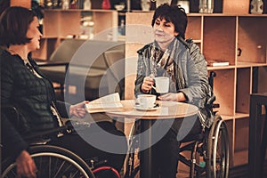 Two physically challenged women in a cafe