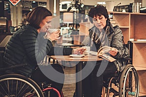 Two physically challenged women in a cafe