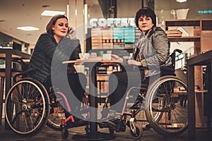 Two physically challenged women in a cafe