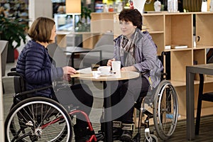 Two physically challenged women in a cafe photo