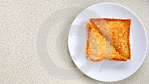 Two piece triangle slices of toasted bread made from white wheat flour and a slice of cheddar cheese in white plate