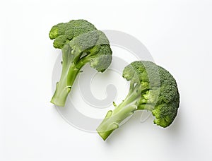 two pieces of broccoli on white background