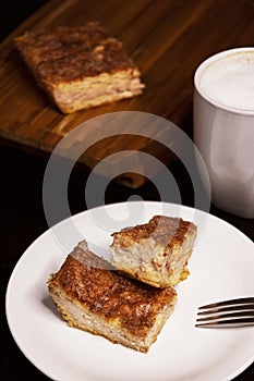 Two pieces of Churro Cheesecake on a white plate