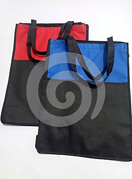 Two pieces of cordura bags. The color combination is black with red and black with blue isolated by a white background photo