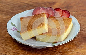 Two pieces of fiadone - Corsican cheesecake, on a saucer photo