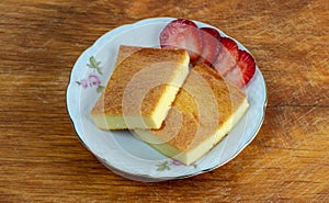 Two pieces of fiadone - Corsican cheesecake, on a saucer photo