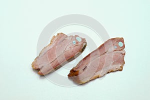 Two pieces of fried pork on a white background