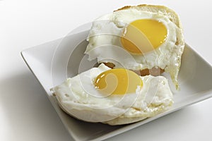 Two pieces of fried sunny side eggs on English Muffins