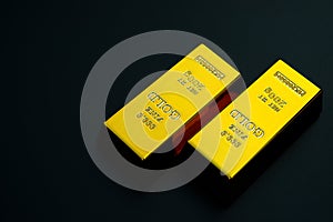 Two pieces of gold bar on black background