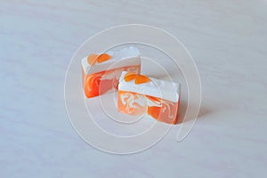 Two pieces of handmade orange soap