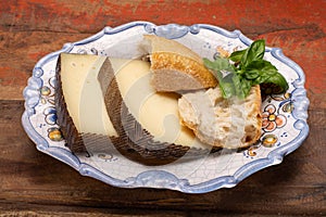 Two pieces of Manchego, queso manchego, cheese made in La Mancha region of Spain from the milk of sheep of the manchega breed photo