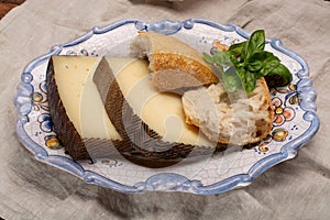 Two pieces of Manchego, queso manchego, cheese made in La Mancha region of Spain from the milk of sheep of the manchega breed photo