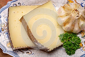 Two pieces of Manchego, queso manchego, cheese made in La Mancha region of Spain from the milk of sheep of the manchega breed photo