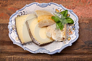 Two pieces of Manchego, queso manchego, cheese made in La Mancha region of Spain from the milk of sheep of the manchega breed photo