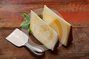 Two pieces of Manchego, queso manchego, cheese made in La Mancha region of Spain from the milk of sheep of the manchega breed photo