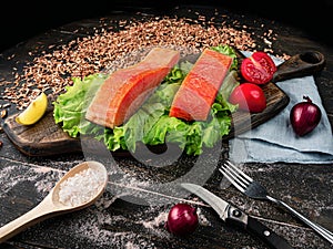 Two pieces of smoked fish Pink salmon on shale board. Fish close up.