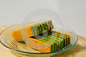 Two pieces of yellow-green lapis legit cake