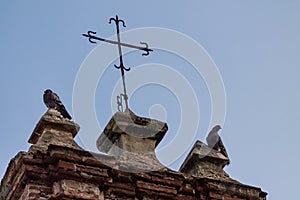 Two pigeons perched on a Chapel at Pigeon Park