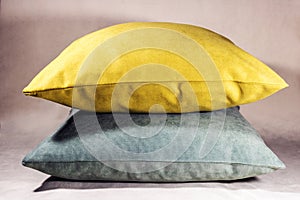 Two pillows aranged horizontaly on a white velvet background