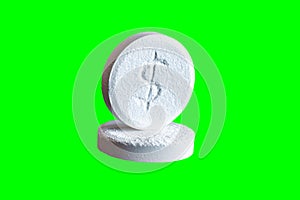 Two pills with dollar sign engraved Isolated On Green Chroma Key Background