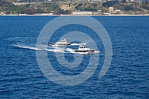 Two Pilot Boats Circling in Blue Water