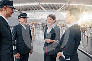 Two pilots communicating with flight attendants before the flight