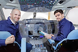 two pilots operate switches aircraft system