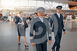 Two pilots walking along the airport terminal