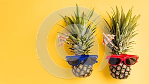 Two pineapples in sunglasses