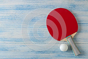 Two ping pong rackets. Table tennis rackets and a ball on a blue wooden table. sport game. top view