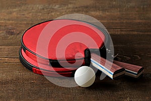 Two ping pong rackets. Table tennis rackets and a ball on a brown wooden table. sport game
