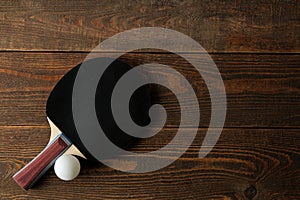 Two ping pong rackets. Table tennis rackets and a ball on a brown wooden table. sport game. top view