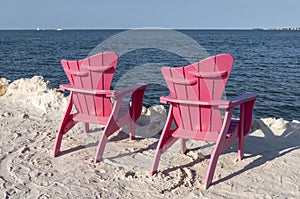 Two Pink Adirondack Chairs by the Seashore photo