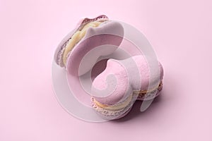 Two pink cakes macarons in a heart form, pastel colors. Small sweet cakes