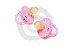 Two pink dummies or pacifiers