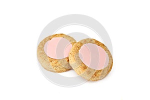 Two pink filling tartlets isolated on white background