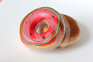 Two pink glazed Donuts covered with sugar crumbs in white background isolated close-up. Valentine's donuts. top view